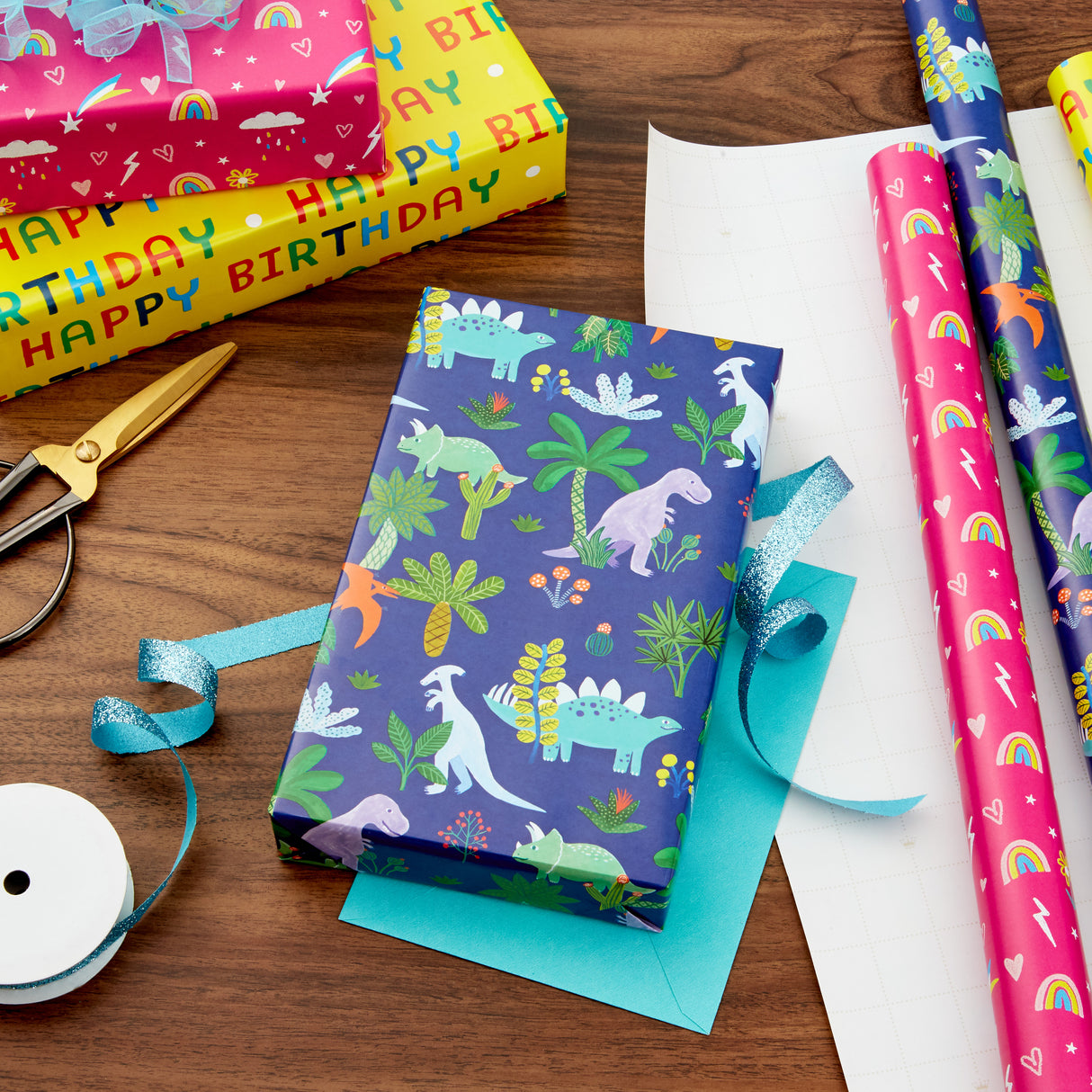 Kids Birthday Wrapping Paper (3 Rolls: 75 sq. ft. ttl) Pink Rainbows, Blue Dinosaurs, Yellow "Happy Birthday"